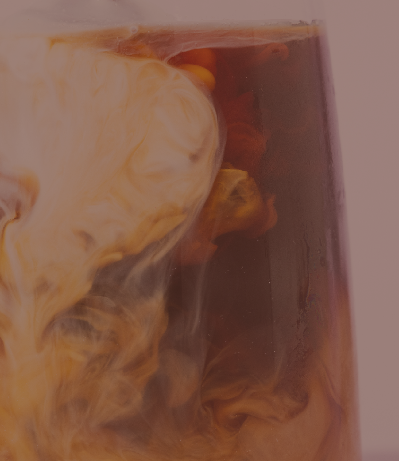 Cold Brew with a milk swirl pouring in