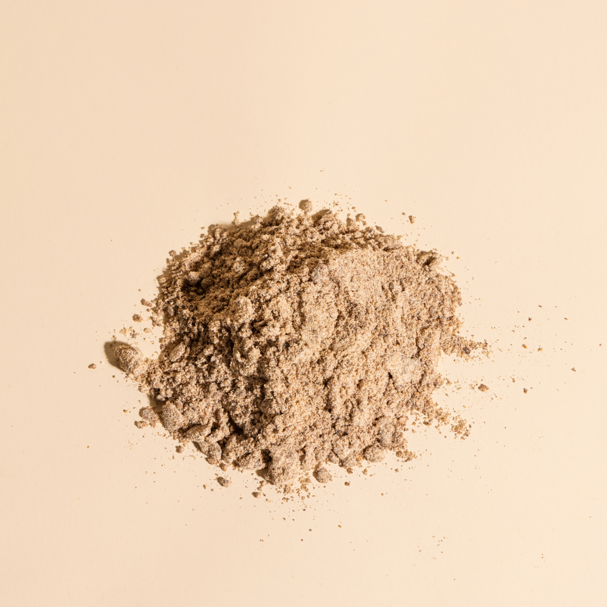 Compound's Instant Oat Milk Latte Powder over a beige background